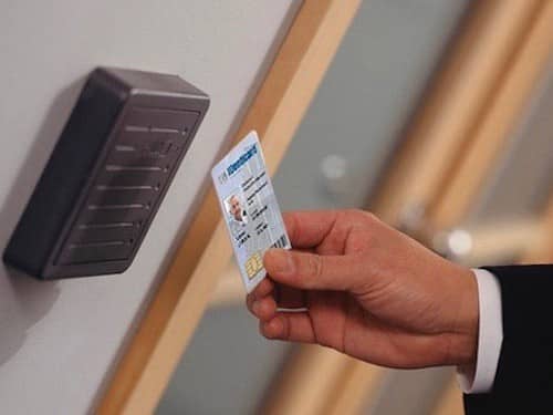 image of a key card being swiped in front of an access control panel next to an office door