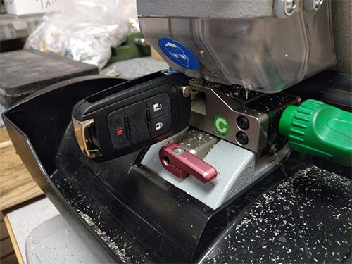 image of an automotive transponder key being cut